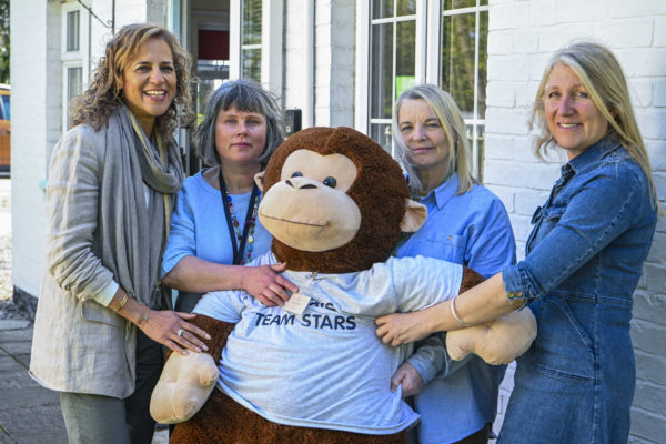 The Ormiston Families Stars team pose with a giant cuddly toy