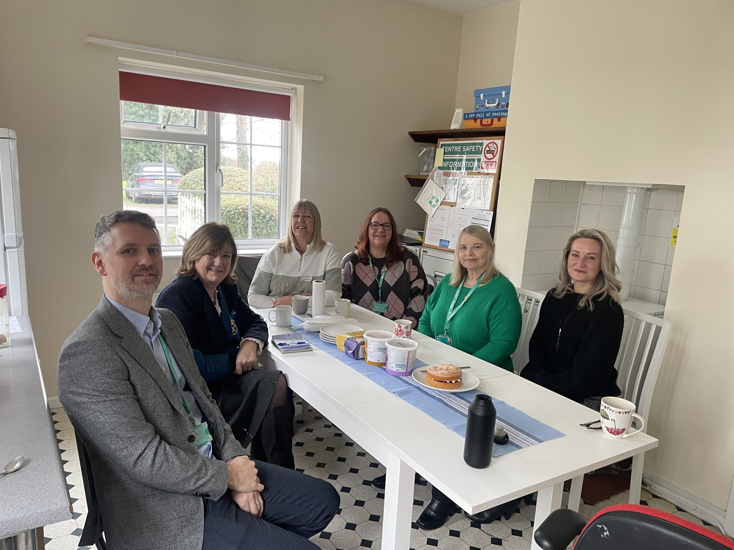 People sitting round a kitchen table.